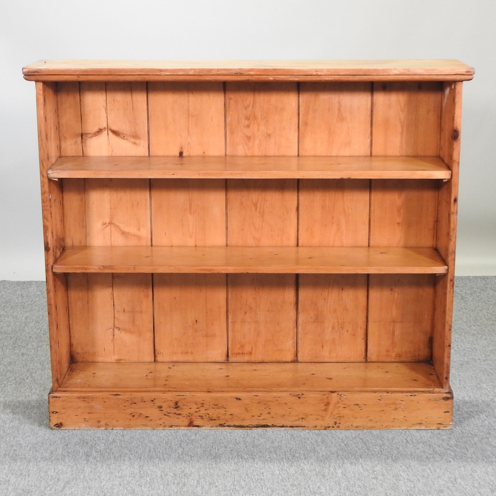 An antique pine dwarf open bookcase,