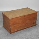 A 19th century stained pine box, with a hinged lid,
