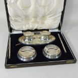 An early 20th century silver desk set, comprising a double inkwell, a pair of pens and two stands,