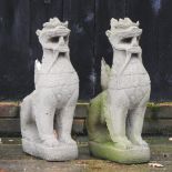 A pair of reconstituted stone models of Chinese dogs,