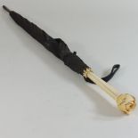 An early 20th century ivory handled umbrella, stamped Bencox London,