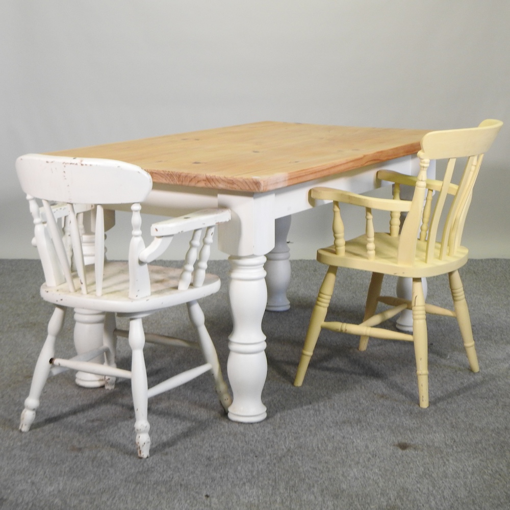 A pine dining table, on white painted turned legs, 148 x 89cm,