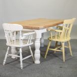 A pine dining table, on white painted turned legs, 148 x 89cm,