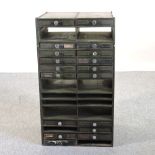 A metal cabinet, containing an arrangement of drawers,