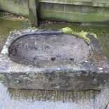 An antique carved stone sink,