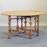 A light oak gateleg dining table,