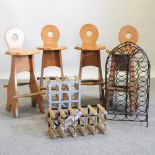 A set of four wooden stools, together with three wine racks,