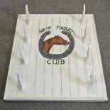 A white painted wooden whip rack,