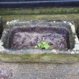 An antique carved stone sink,