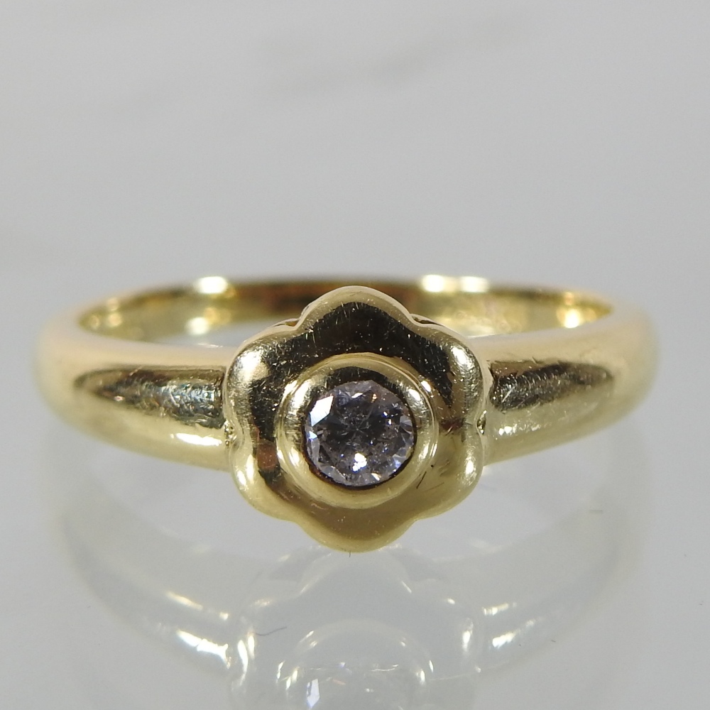 An 18 carat gold solitaire diamond ring,