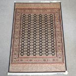 A Bokhara carpet, with all over design on a blue ground,