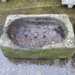 An antique carved stone sink,