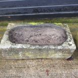 An antique carved stone sink,