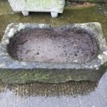 An antique carved stone sink,