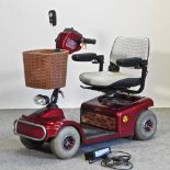 A red Shoprider mobility scooter,