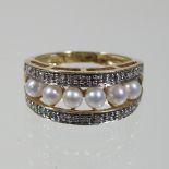 A 9 carat gold pearl and diamond eternity ring,
