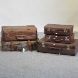 A collection of five vintage leather suitcases,