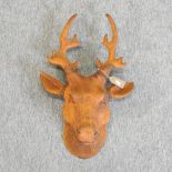 A rusted metal model of a large deer head,