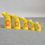 A set of five yellow Shell oil cans,