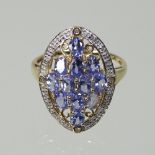 A 9 carat gold blue tanzanite and diamond cluster ring,