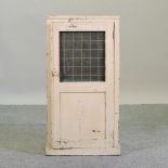 An early 20th century painted cabinet, with a wirework door,