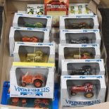 A collection of boxed diecast toy tractors