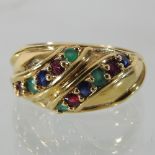 An 18 carat gold multi gem set ring, set with two rows of diamonds, emeralds and sapphires,