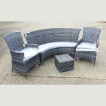 A rattan three seater curved bench, 160cm, together with two armchairs, with cushions,