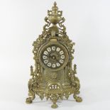 An ornate brass mantel clock,