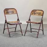 A pair of painted metal folding cafe chairs