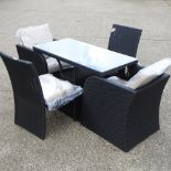 A black rattan table, with a glass top, 120 x 60cm,