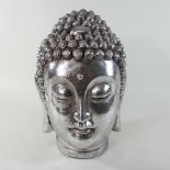 A silver painted buddha head,