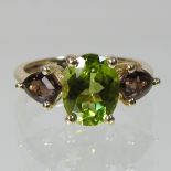 A 9 carat gold peridot and quartz ring,