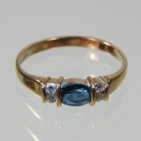 A 9 carat gold blue topaz and gem set ring