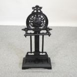 A Victorian style black painted metal umbrella stand,