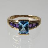 A 9 carat gold blue topaz and amethyst ring,