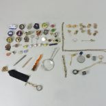 A collection of enamelled badges, cufflinks, propelling pencils,