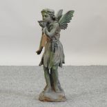 A painted metal garden figure of a fairy, drinking from a shell,