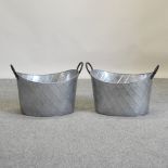 A pair of large galvanised oval planters,