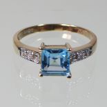 A 9 carat gold blue topaz and diamond ring,