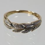 A 9 carat gold ring, with leaf design,