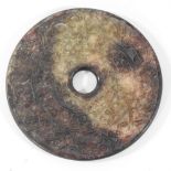 A jade coloured hardstone disc,