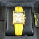 A Newton and Sons Royal Cube wristwatch, on a yellow leather strap,