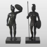 A pair of bronze figures of Roman gladiators, each shown standing, on a square plinth base,