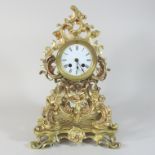 A 19th century brass cased eight day mantel clock, of foliate design,