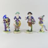 A pair of German Volkstedt porcelain figures of jesters, 19cm high,