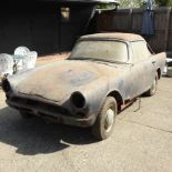 A 1965 blue Sunbeam Alpine two seater coupe sports car, in barn find condition for restoration.