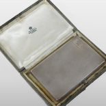 An early 20th century silver pocket cigarette case, with engine turned decoration,