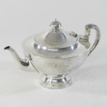 An Edwardian Arts and Crafts teapot and cover, of circular pedestal shape,