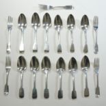 A matched set of twelve George IV silver fiddle pattern table spoons, London from 1820 onwards,